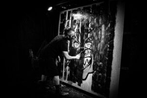 A person on stage painting